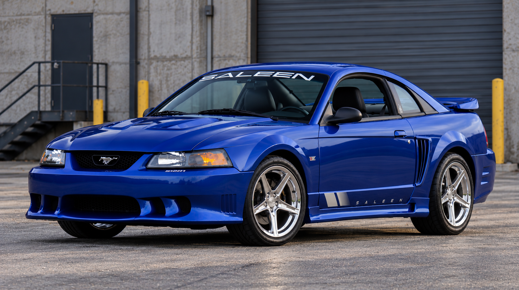 Blue Saleen Mustang from the SN95/New Edge era viewed from the front three-quarter angle.